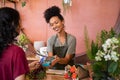 Customer paying with contactless credit card at flower shop Royalty Free Stock Photo
