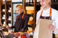 Customer paying for order of cheese in grocery shop. Royalty Free Stock Photo