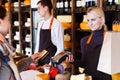 Customer paying for order of cheese in grocery shop. Royalty Free Stock Photo