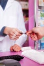 Customer paying with credit card for pills