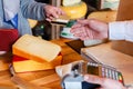 Customer paying for order of cheese in grocery shop. Royalty Free Stock Photo