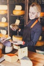 Customer paying for order of cheese in grocery shop. Royalty Free Stock Photo