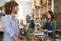 Customer Paying For Shopping At Checkout Of Sustainable Plastic Free Grocery Store