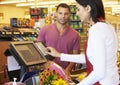 Customer Paying For Shopping At Supermarket Checkout