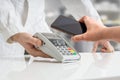 Customer is paying with smartphone using NFC technology in pharmacy Royalty Free Stock Photo