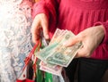 Customer pays dirhams UAE bills cash while shopping.