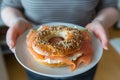 customer with a plate of smoked salmon and cream cheese on a bagel Royalty Free Stock Photo