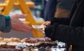 Customer purchasing pastries at Prague farmers market.