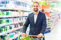 Customer with pushcart in supermarket Royalty Free Stock Photo