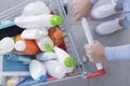 Customer pushing a shopping cart with cleaning products