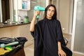 Customer puts hairdryer to her head, hairsalon Royalty Free Stock Photo