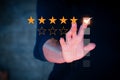 Customer review concept. Businessman hand with rating stars. Royalty Free Stock Photo