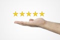 Customer review concept.. Rating golden stars. Feedback, reputation and quality concept. Hand holding golden five star rating. Royalty Free Stock Photo