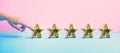 Customer review concepts with female finger and five gold star on pastel color background