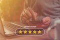 Customer review and five star rating concept, using smartphone and laptop for online service rate Royalty Free Stock Photo