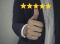 Customer review good rating concept hand pressing five star on visual screen and positive customer feedback testimonial Royalty Free Stock Photo