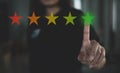 Customer review good rating concept hand pressing five star on visual screen and positive customer feedback testimonial Royalty Free Stock Photo