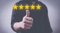 Customer review good rating concept hand pressing five star on visual screen and positive customer feedback testimonial Royalty Free Stock Photo