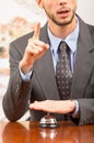 Customer ringing hotel bell at reception desk Royalty Free Stock Photo