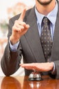 Customer ringing hotel bell at reception desk Royalty Free Stock Photo