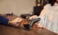 The customer`s hand pays for a contactless credit card with NFC technology. Bartender with a Credit Card reader. Focus on hands Royalty Free Stock Photo