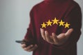 Customer satisfaction concept. hand of the customer, client, or user holding the stars Royalty Free Stock Photo