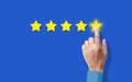 Customer satisfaction Concept. hand Rating five Star on blue background. Satisfied Client and very good Service Review concept Royalty Free Stock Photo