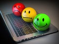 Customer satisfaction h feedback rating concept. Colored smile emoticons on laptop keyboard Royalty Free Stock Photo