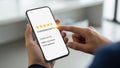 Customer satisfaction and review concept. Client using smartphone to give excellent five-star rating and feedback Royalty Free Stock Photo