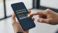 Customer satisfaction and review concept. Client using smartphone to give excellent five-star rating and feedback Royalty Free Stock Photo
