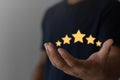 Customer satisfaction, service rating Five Star Satisfaction concept. hand of customer or client holding the stars to complete Royalty Free Stock Photo