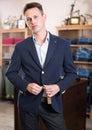 Customer searching new suit in male clothing shop Royalty Free Stock Photo