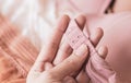 A customer selects a product and touches the lace material of beige bra hooks in the store with her hand Royalty Free Stock Photo