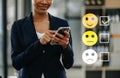 Customer service evaluation concept. woman Show face smile emoticon show on virtual screen from hand.looking at smart phone, Royalty Free Stock Photo