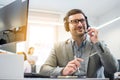 Customer service operator man with headset listening to a client with attention while working in call center. Royalty Free Stock Photo