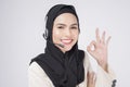 Customer service operator muslim woman in suit wearing headset over white background studio Royalty Free Stock Photo