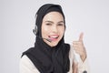 Customer service operator muslim woman in suit wearing headset over white background studio Royalty Free Stock Photo