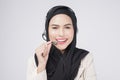 Customer service operator muslim woman in suit wearing headset over white background studio Royalty Free Stock Photo