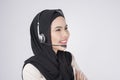 Customer service operator muslim woman in suit wearing headset over white background studio Royalty Free Stock Photo