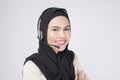 Customer service operator muslim woman in suit wearing headset over white background studio Royalty Free Stock Photo
