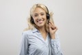 Customer service operator. Portrait of happy female call center representative in headset, posing over grey background Royalty Free Stock Photo