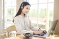 Customer service operator woman in headset using computer answering customer call in office