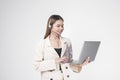 Customer service operator woman in suit wearing headset over white background studio Royalty Free Stock Photo