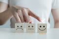 Customer service rating experience and feedback emotion and satisfaction. Hand choose 5 star happy smiley face icon on wood cube. Royalty Free Stock Photo