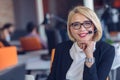 Customer service representative at work. Beautiful young woman in headset working at the computer Royalty Free Stock Photo