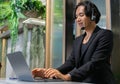 Customer service talking and helping the client. A call center of telemarketing business using headset, microphone and computer