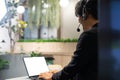 Customer service talking and helping the client. A call center of telemarketing business using headset, microphone and computer