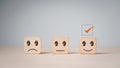 Customer services best excellent business rating experience. Satisfaction survey concept.Chooses a smile face on wood block cube Royalty Free Stock Photo