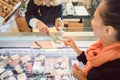 Customer and shop clerk at the cheese counter of supermarket Royalty Free Stock Photo