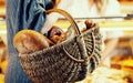 Customer shopping bread in baker carrying basket